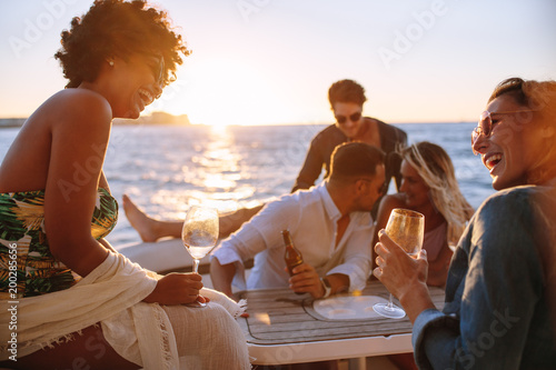 Friends at sunset boat party © Jacob Lund
