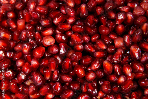 Food background of the fresh ripe pomegranate seeds