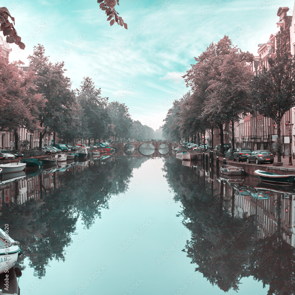 Houses and Boats on Amsterdam Canal. Morning photo of colored houses in the Dutch style with reflection in water
