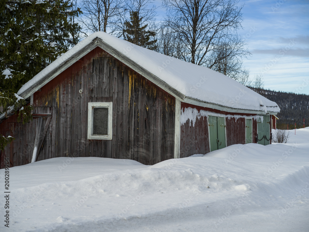Barn in a snow covered field, Arjeplog, Norrbotten County, Lapland, Sweden Barn in a snow covered field, Arjeplog, Norrbotten County, Lapland, Sweden