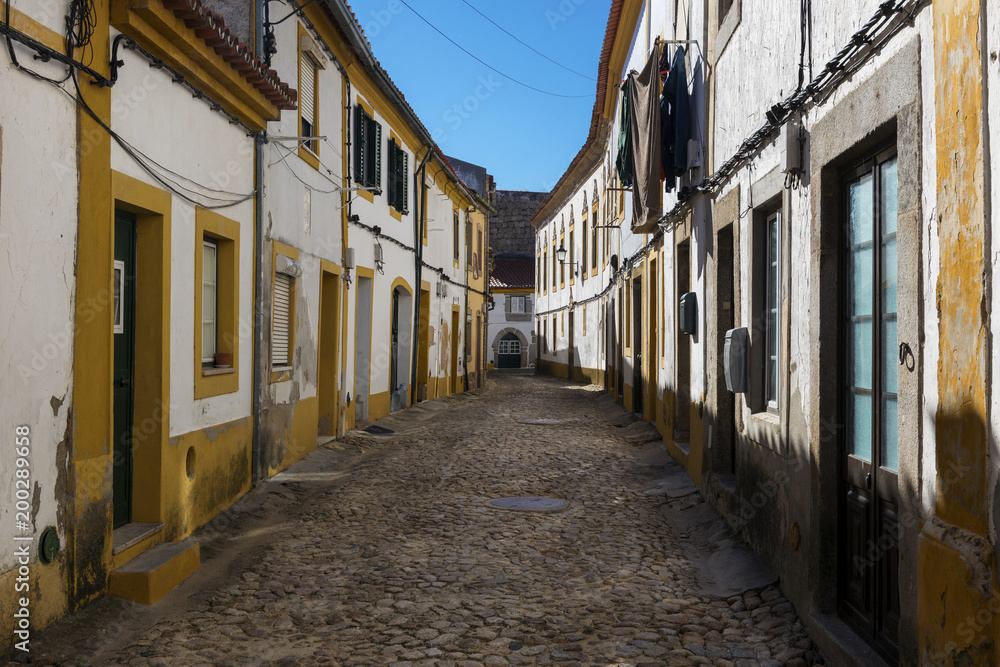 View of a narrow cobblestone street in the village of Nisa, Alentejo, Portugal; Concept for travel in Portugal and discover Portugal