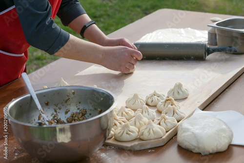 Khinkali cooking. Georgian trafitional local dish. Women cooks meat dumplings for her family. photo