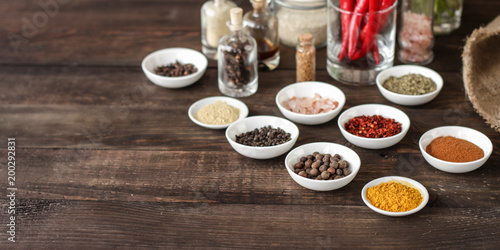 Spices and herbs. Variety of spices and herbs on a dark wooden surface