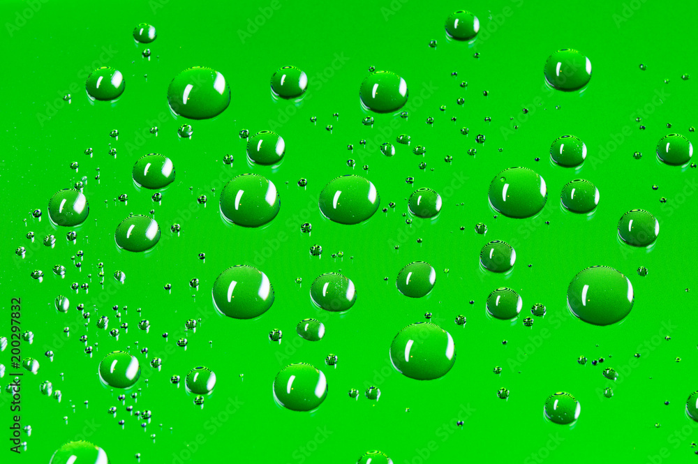 Round water droplets background with a pattern of pixels in a bright green colour.