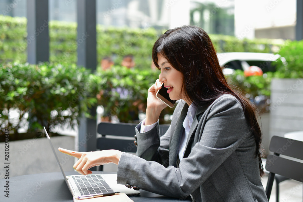 Business Concept.Young Asian businesswoman is working happily.Young businesswoman working in a cafe.Young businesswoman is relaxation in a coffee shop. Business Concept.Young Asian businesswoman is working happily.Young businesswoman working in a cafe.Young businesswoman is relaxation in a coffee shop.