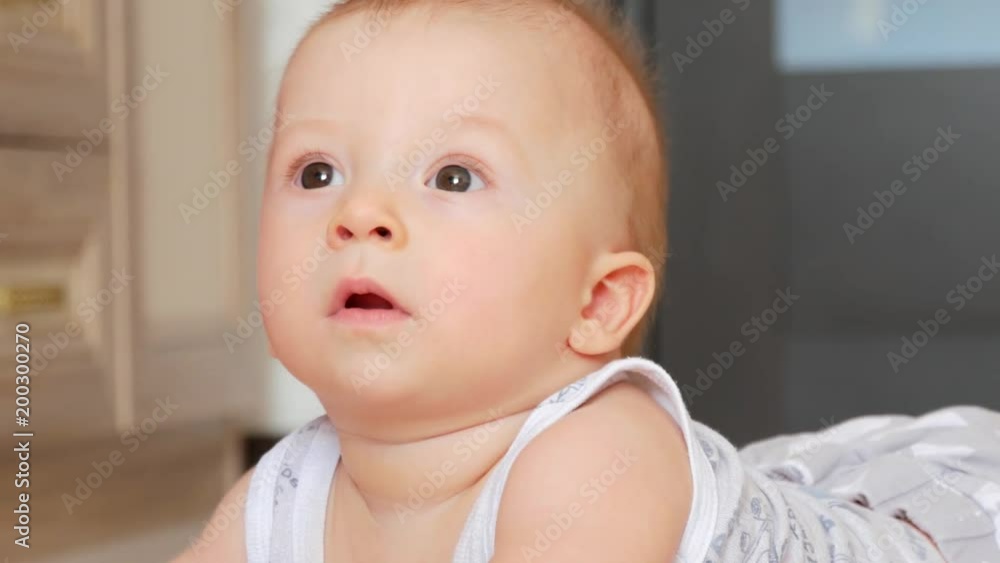 Portrait of smiling happy 6 month old baby boy indoors. Close Up. Portrait of smiling happy 6 month old baby boy indoors. Close Up.