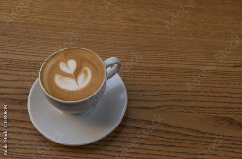 A cup of coffee on wooden table.