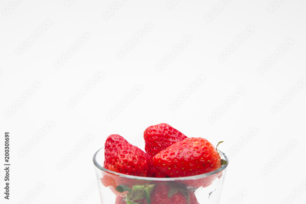 Strawberries in a glass on white bakcground 