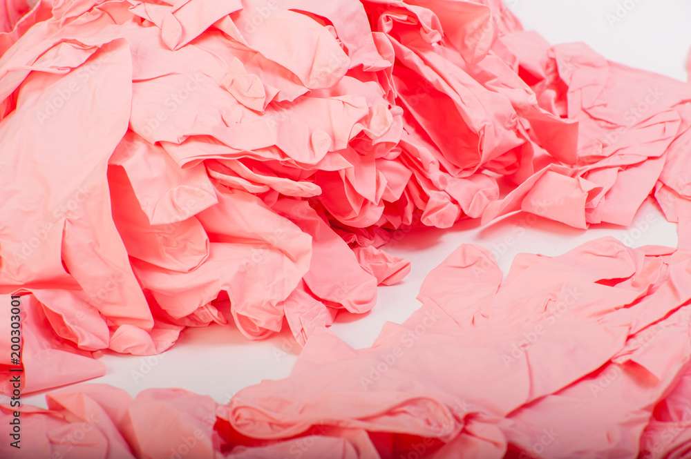 A lot of pink latex medical rubber gloves A lot of pink latex medical rubber gloves