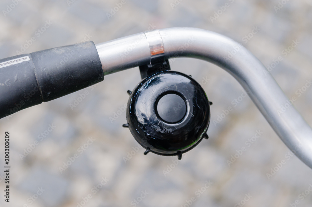 Fotografie Black bell on a bicycle handlebars