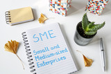 ME Small And Medium-sized Enterprises written in a notebook on white table