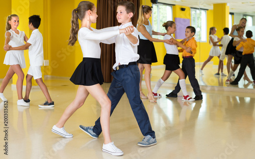 Positive kids are dancing waltz