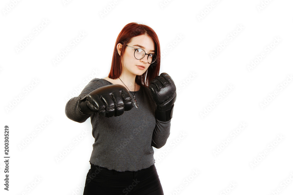 Young woman with red hair and boxing gloves ready for fight isolated over white background Young woman with red hair and boxing gloves ready for fight isolated over white background