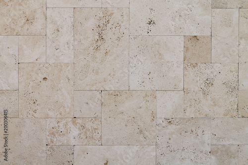 Natural Italian stone. Smooth travertine surface. A sample of wall cladding with natural stone.	 photo