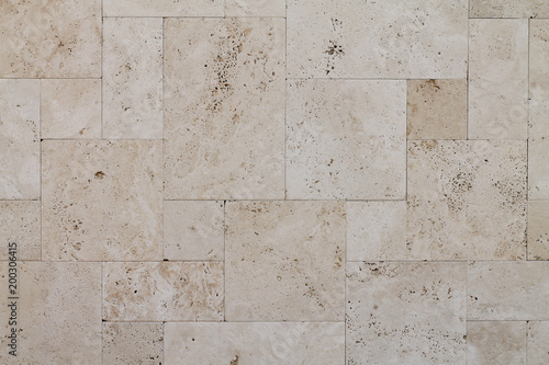 Natural Italian stone. Smooth travertine surface. A sample of wall cladding with natural stone.	