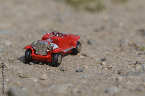 Small red oldtimer toy car on driving on a lane outdoor © antreas8n5