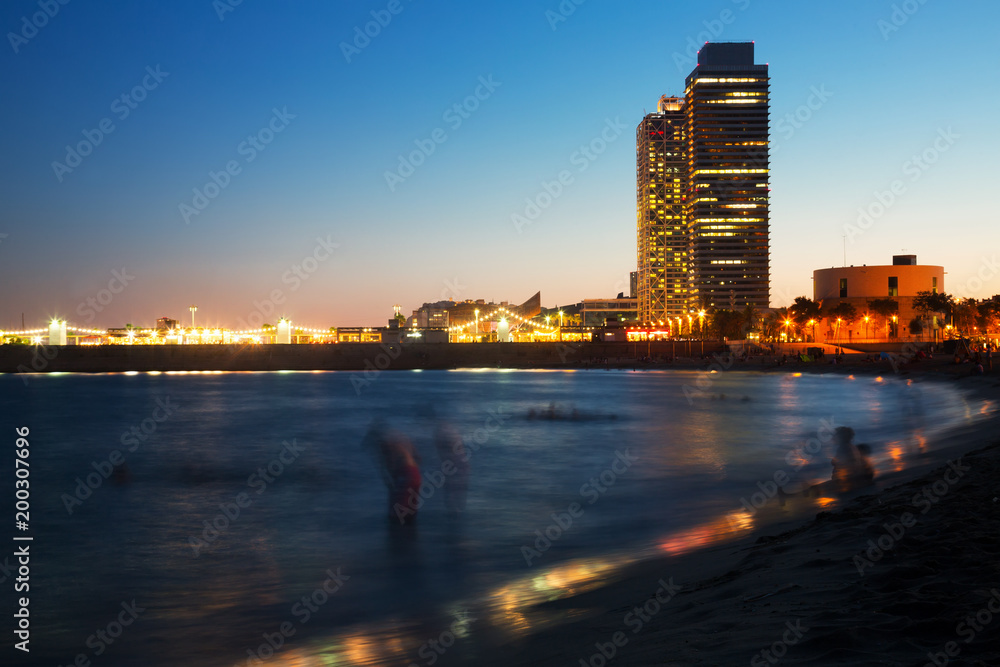 Fototapeta premium Barceloneta beach with skyscrapers in sunset