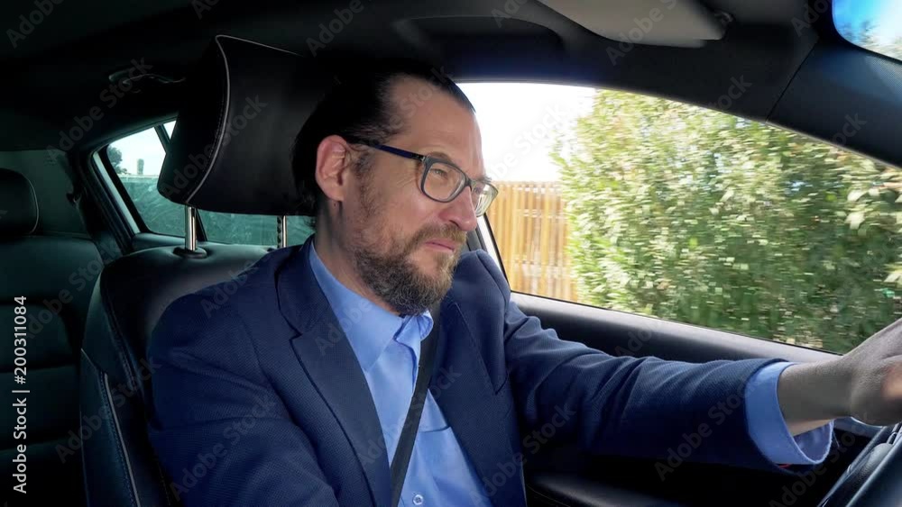 Sad business man crying while driving car