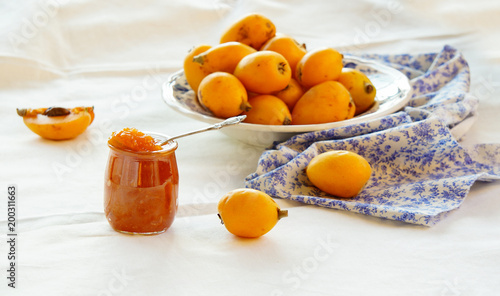 Canvastavla homemade loquat jam on the white background, Contre-jour light