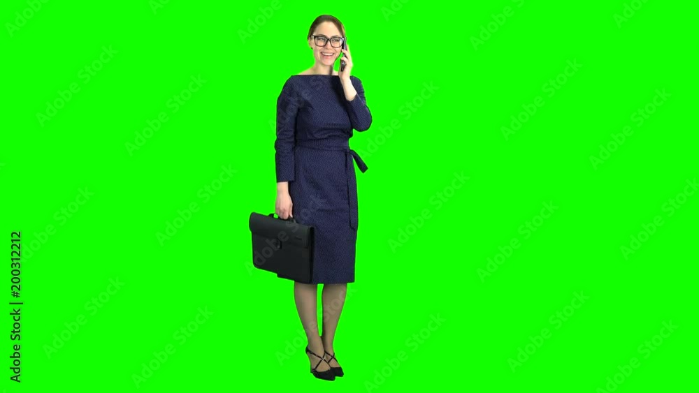 Businesswoman stand and talking on the phone. Green screen Businesswoman stand and talking on the phone. Green screen