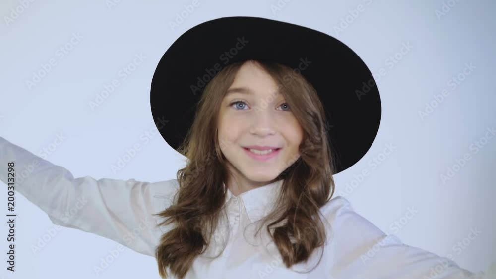 Young girl wondering and stretching out arms at camera. Slowly Young girl wondering and stretching out arms at camera. Slowly
