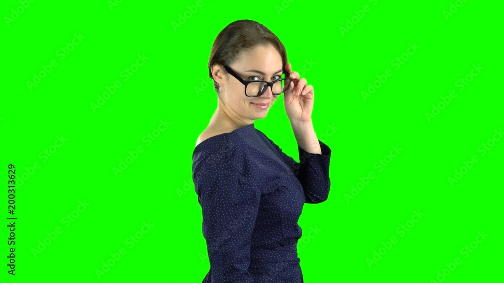 Business lady is walking and waving to her friends. Green screen. Side view Business lady is walking and waving to her friends. Green screen. Side view