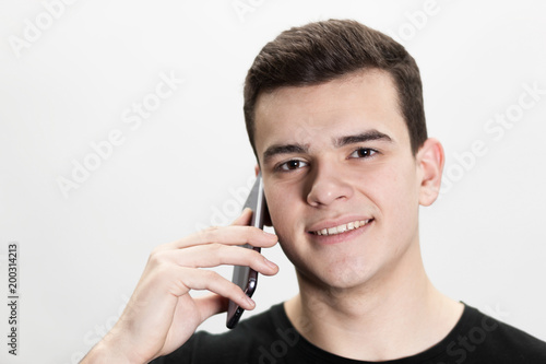 young casual man talking on the phone isolated on white background