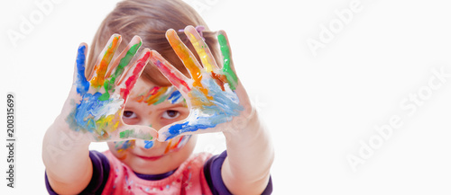 Colorful painted hands in a beautiful young girl (art, childhood, color)