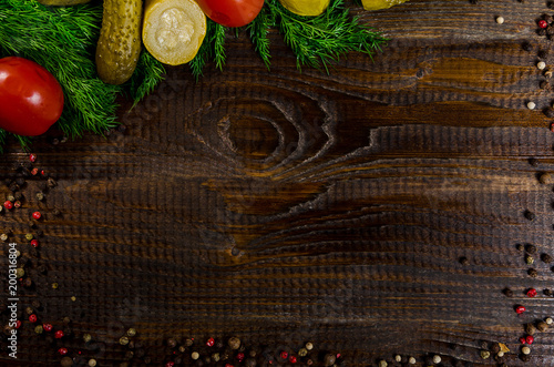 pickles and pepper peas on a dark wooden background, place for the inscription photo