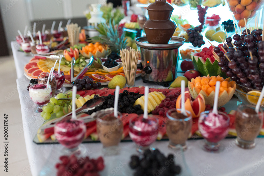 Chocolate Fountain Ice Cream And Fruits For Dessert At Wedding Table