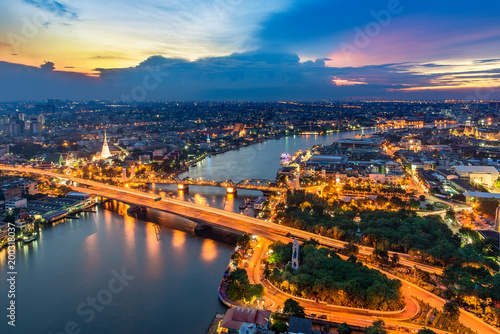 The beautiful of Bangkok city scape areas Phra Buddha Yodfa Bridge for communication between Chaopraya river the capital of Thailand in twilight dramatic sky.