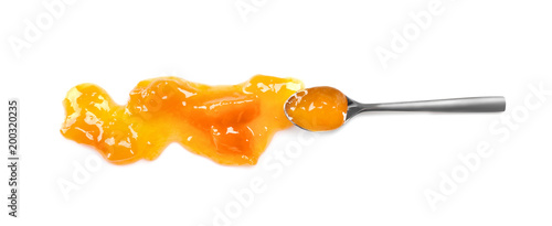 Spoon with sweet jam on white background photo