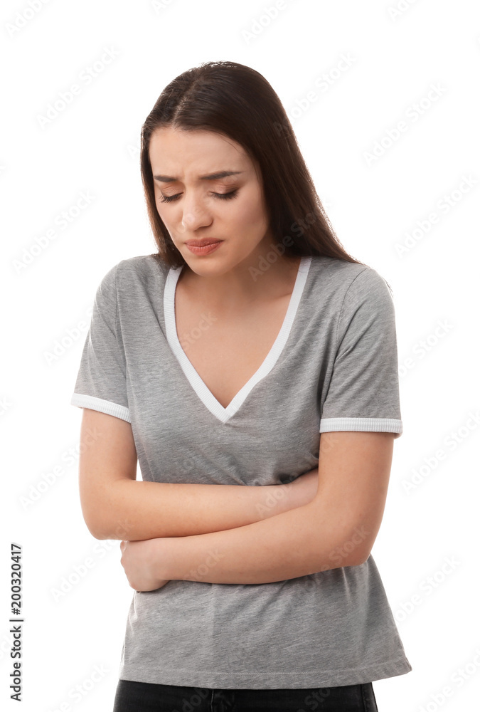 Young woman suffering from abdominal pain on white background Young woman suffering from abdominal pain on white background