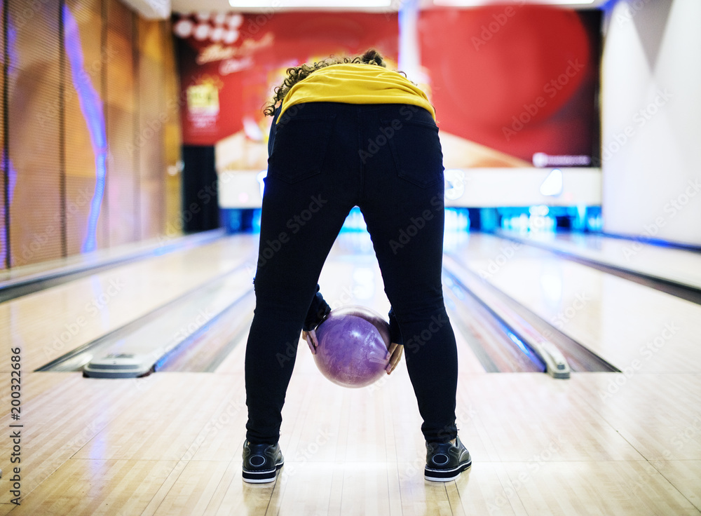 Girl bowling with two hands