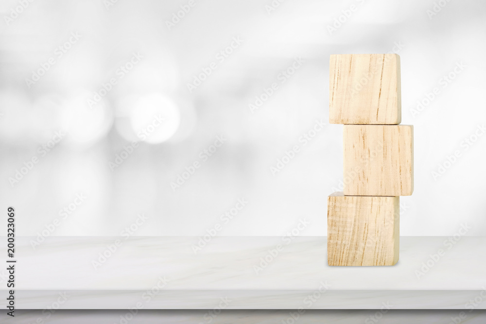 Three wooden cubes on table over blur abstract bokeh light background, mock up, template, banner with copy space for text Three wooden cubes on table over blur abstract bokeh light background, mock up, template, banner with copy space for text