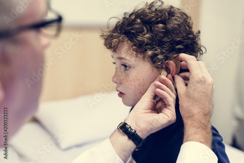 Young boy having his ears checked