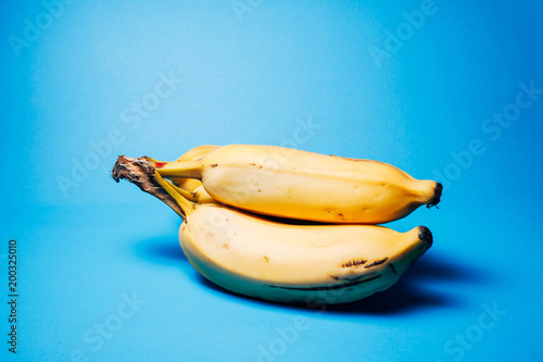 Beautiful, fresh, yellow bananas on the blue background