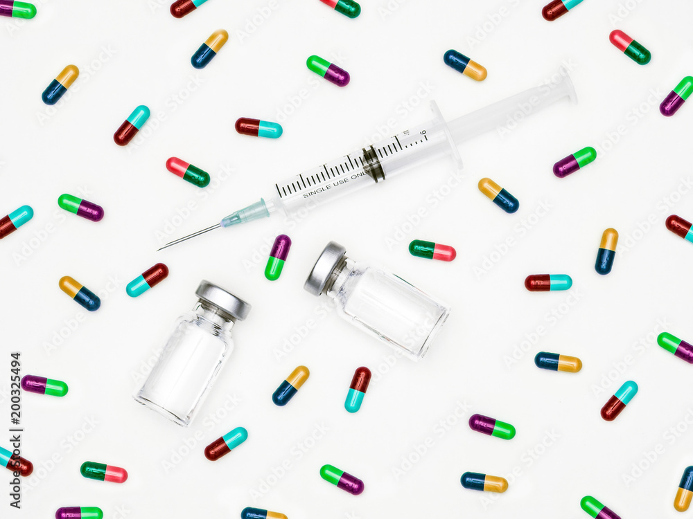 Medicine bottle for injection. Medical glass vials and syringe in laboratory for vaccination. Colorful capsule vaccine for treatment, hospital or pharmacy concept isolated on white background. Medicine bottle for injection. Medical glass vials and syringe in laboratory for vaccination. Colorful capsule vaccine for treatment, hospital or pharmacy concept isolated on white background.