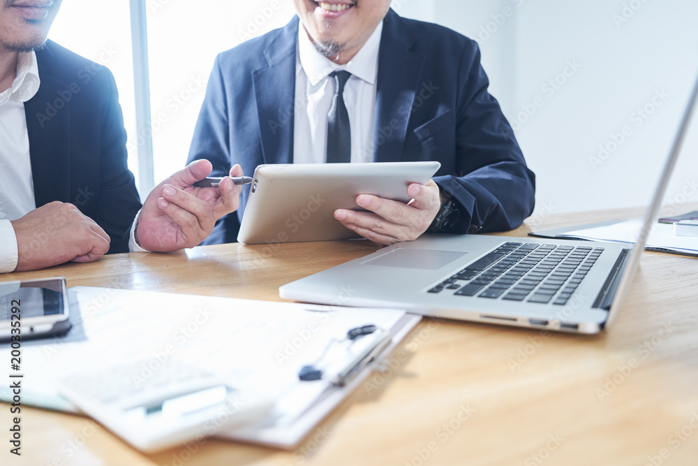 Two businessmen use electronic products in discussing business plan