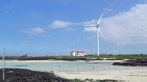 Landscape of coast with wind generator in Gujwa-eup, Jeju, Korea. Jeju Island is famous for beautiful nature and natural World heritage sites. photo