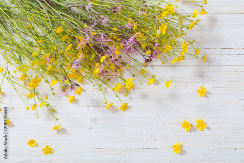 yellow and pink flowers on white wooden background