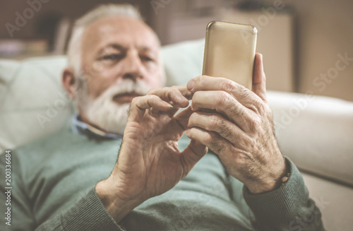 Modern senior man with mobile phone.