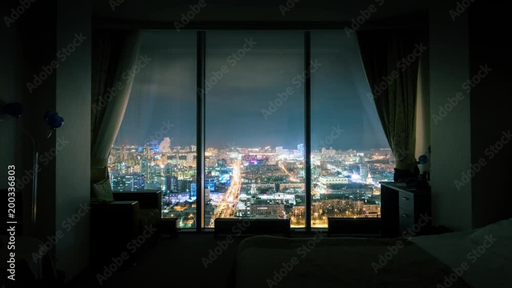 Night city skyline, view from dark room with panoramic window ...