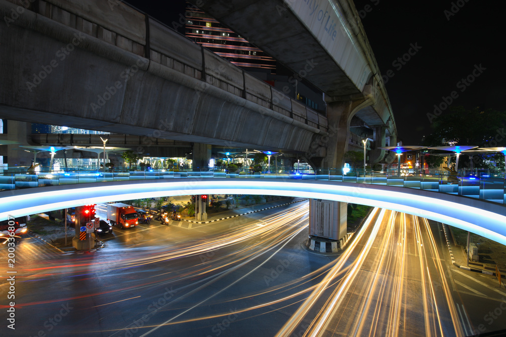 Bangkok,Thailand - 31 October 2017 : Night light with long speed shutter of traffic at MBK, BTS Siam interchange in front of Siam Discovery and Art Museum junction on Halloween night