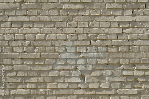 Ziegelsteinmauer gelb mit Schatten und tiefer Struktur