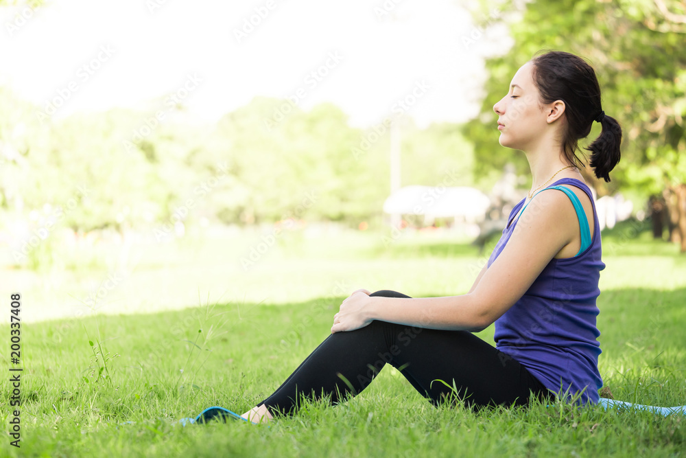Beautiful woman doing yoga exercises in the park. Concept of healthy lifestyle. Beautiful woman doing yoga exercises in the park. Concept of healthy lifestyle.