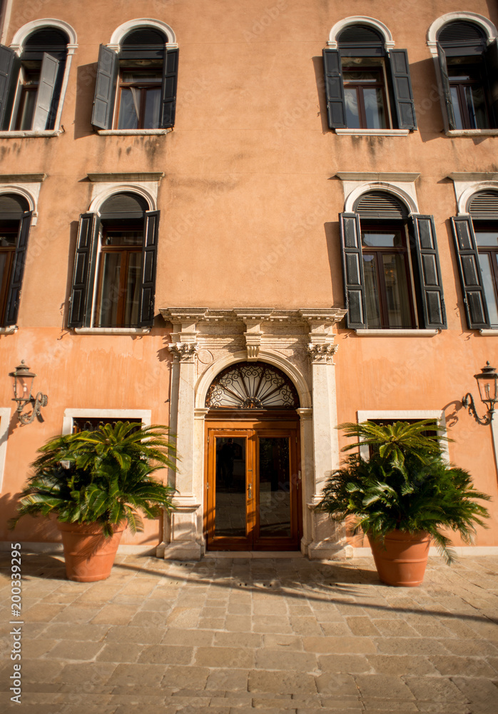 Fototapeta premium Ancient Facade with Wooden Vintage Door and Windows in Venice.