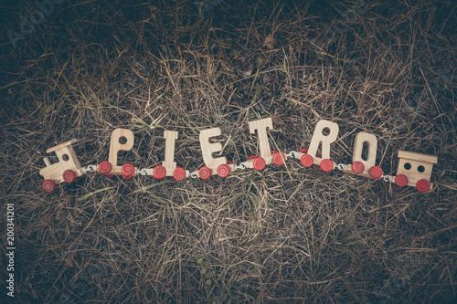 Toy decorating train with letter forming the italian name Pietro