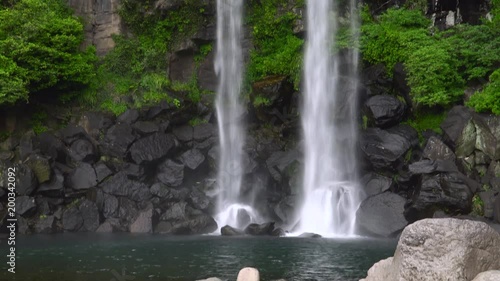 Jeongbang Falls, one of the most famous waterfalls on Jeju Island. The waterfall is 23m high and is an unique waterfall that falls directly into the sea. photo