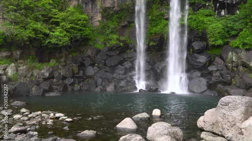 Jeongbang Falls, one of the most famous waterfalls on Jeju Island. The waterfall is 23m high and is an unique waterfall that falls directly into the sea. photo